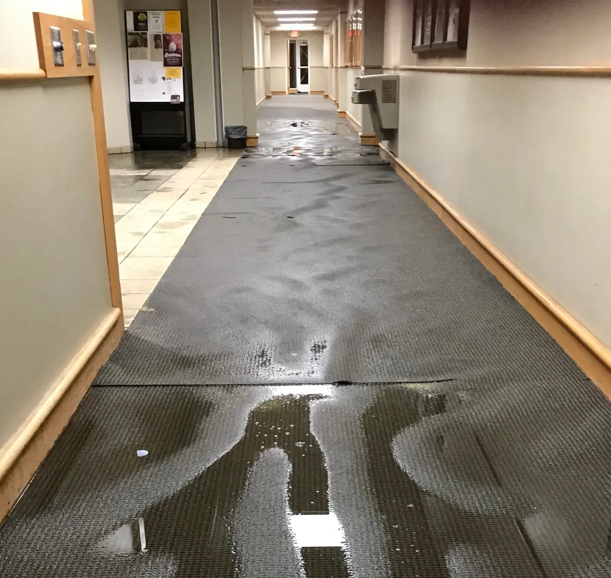 Protected work path through the hallway of an occupied commercial facility